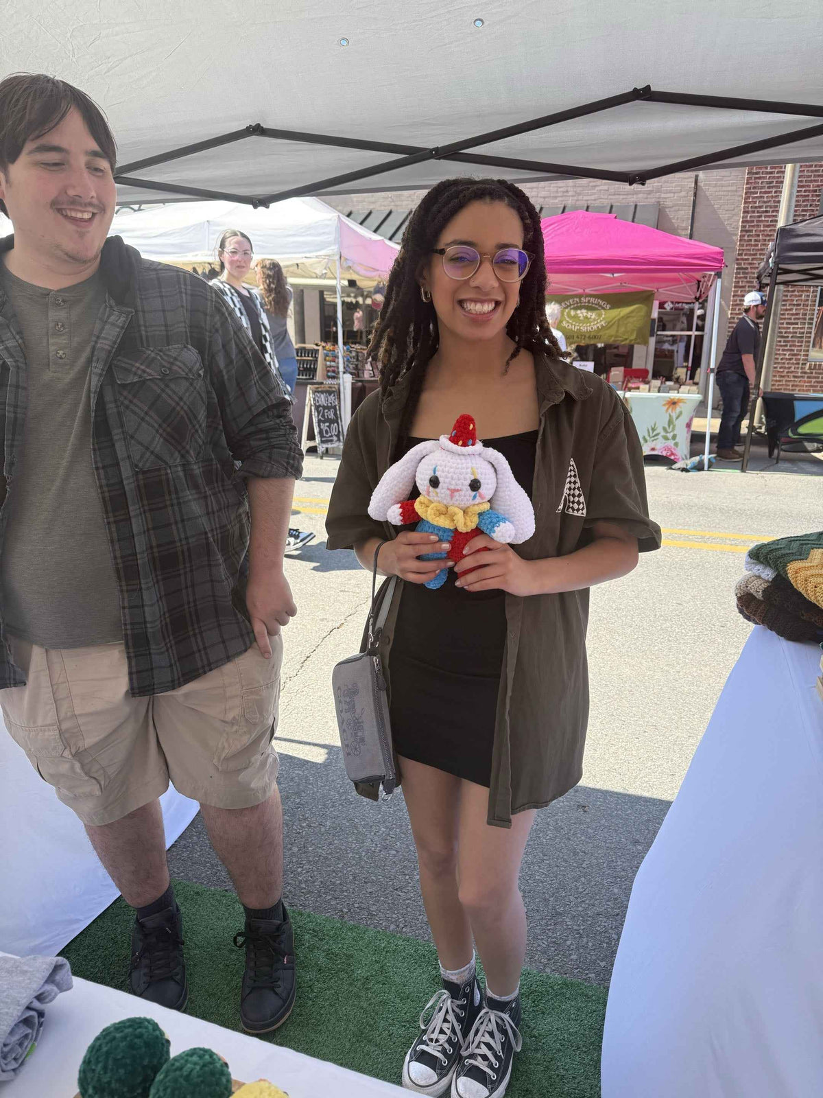 couple holding a clown bunny plushie