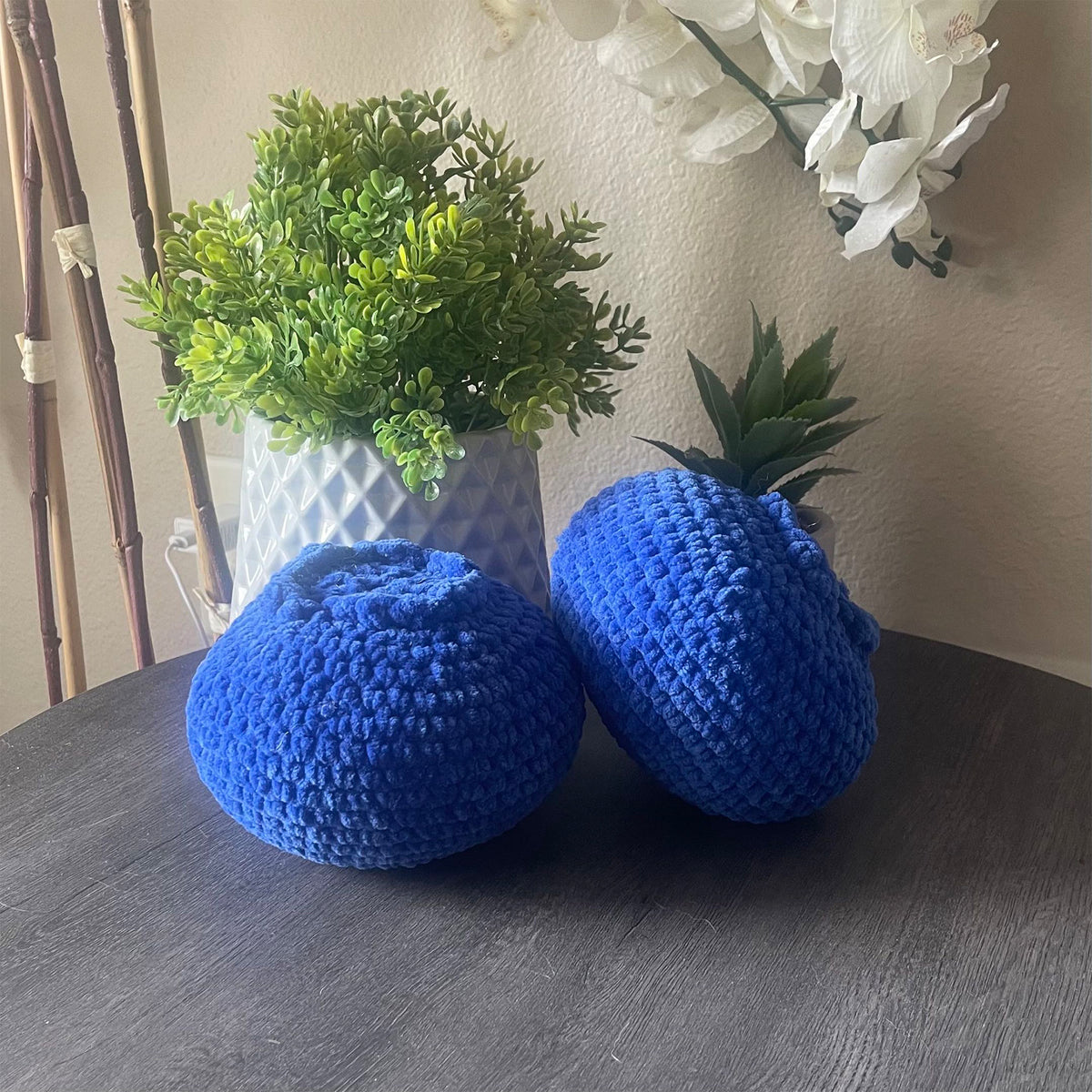 blueberry crochet plushie sitting on a table