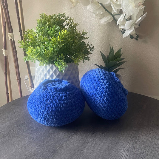 blueberry crochet plushie sitting on a table