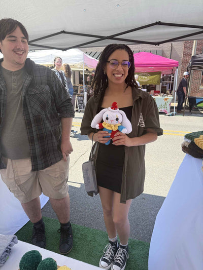 couple holding a clown bunny plushie