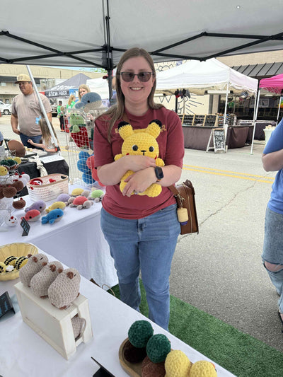 girl holding a jumbo pikachu plushie