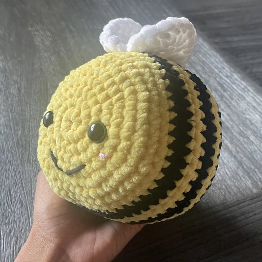 hand holding a jumbo bee plushie